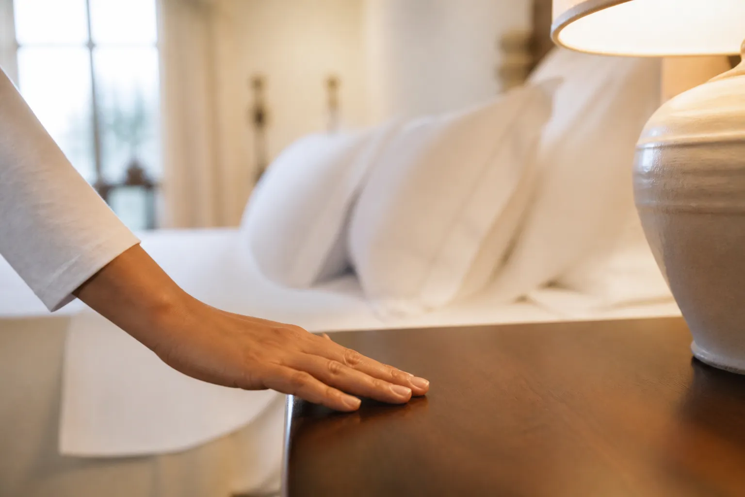 Guest closely inspecting the details of a freshly cleaned hotel room